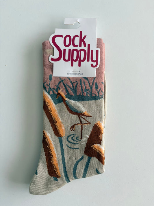 Unisex by Sock Supply features a bird above reeds/cattails socks
