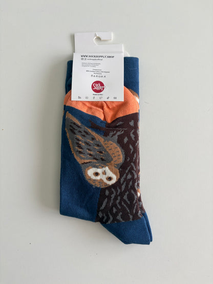 Unisex by Sock Supply. A stylised bird perched beside a tree trunk.